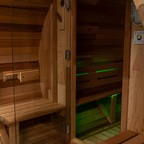 Wooden sauna interior with green lights on the floor
